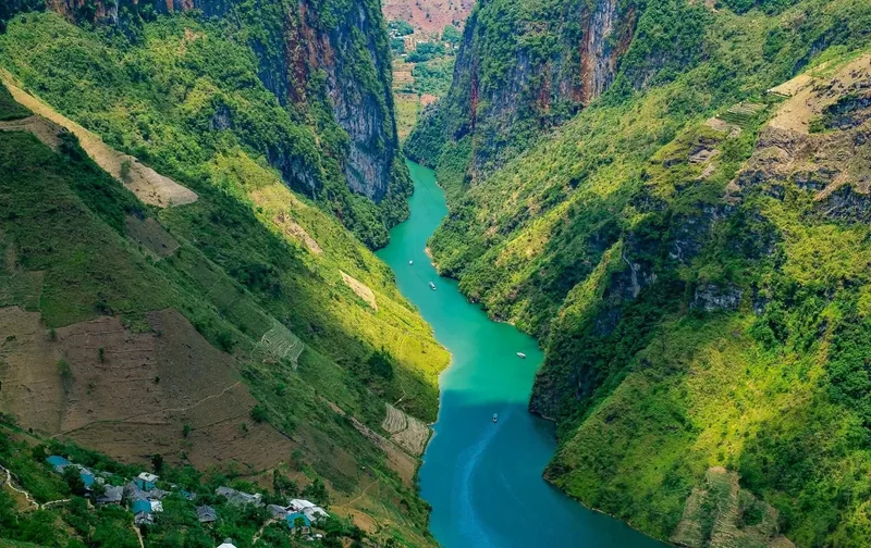 Turquoise river winds through the deep limestone canyon of Nho Que in Ha Giang.