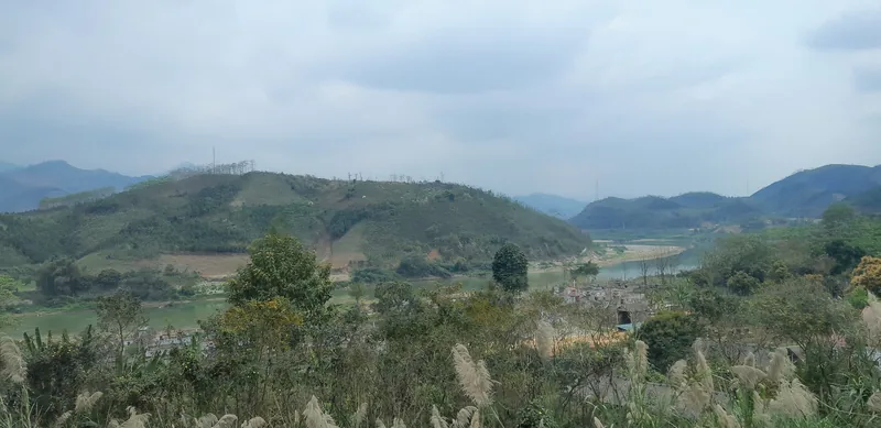 Rolling green hills frame the Red River valley near the China border in Lao Cai province. Rolling green hills frame the Red River valley near the China border in Lao Cai province.