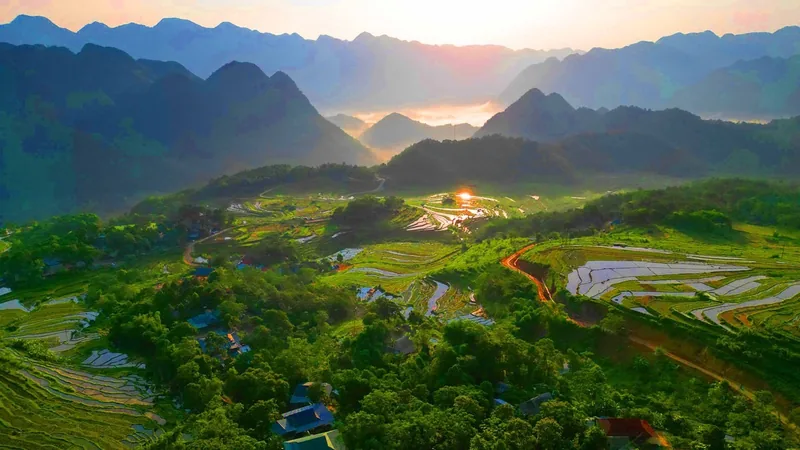 Sunrise light spreads across water-filled rice terraces and forested hills in Pu Luong valley. Sunrise light spreads across water-filled rice terraces and forested hills in Pu Luong valley.